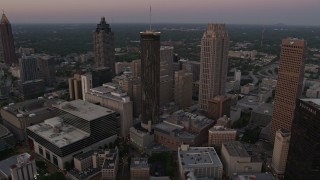 AX40_004E - 4.8K aerial stock footage flying over Downtown toward Westin Peachtree Plaza Hotel, Atlanta, Georgia, twilight