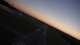 AX40_018 - 4.8K aerial stock footage flying over the runway at Fulton County Airport, Georgia, sunset