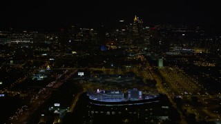 AX41_005E - 4.8K stock footage aerial video approach and bird's eye of Turner Field, tilt to reveal Downtown Atlanta skyline, Atlanta, Georgia, night