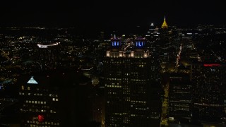 AX41_011E - 4.8K stock footage aerial video orbit the tops of skyscrapers, Downtown Atlanta, Georgia, night