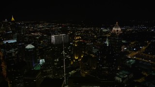 AX41_031 - 4.8K aerial stock footage flying by skyscrapers towering over the city, Midtown Atlanta, Georgia, night