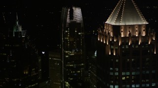 AX41_033E - 4.8K aerial stock footage orbit 1180 Peachtree revealing GLG Grand and other nearby skyscrapers, Midtown Atlanta, night