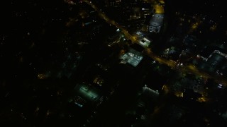 AX41_053 - 4.8K aerial stock footage following a road through the city, Buckhead, Georgia, night