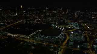 AX41_064 - 4.8K aerial stock footage flying away from Georgia Dome revealing downtown skyline, Atlanta, night