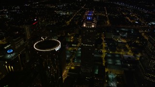 AX41_065E - 4.8K stock footage aerial video approaching skyscrapers, tilt to bird's eye of 191 Peachtree, Downtown Atlanta, Georgia, night