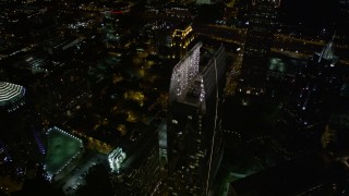AX41_072E - 4.8K aerial stock footage approach and tilt to bird's eye of 1180 Peachtree and GLG Grand, Midtown Atlanta, night
