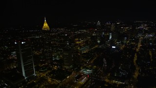 AX41_074E - 4.8K aerial stock footage flying by skyscrapers toward downtown, Midtown Atlanta, Georgia, night