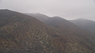 AX42_056 - 5K aerial stock footage of the Santa Monica Mountains with fog, California