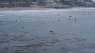 AX42_078 - 5K stock footage aerial video surfers in the Pacific Ocean near the beach, Malibu, California