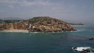 AX42_086E - 5K aerial stock footage of a sparsely populated beach and Point Dume, seen from the ocean, Malibu, California