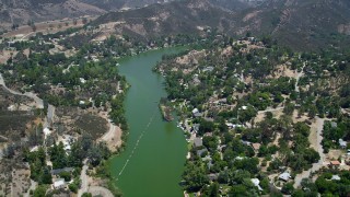 AX42_113 - 5K stock footage aerial video fly over Malibu Lake and lakefront homes homes, Agoura Hills, California