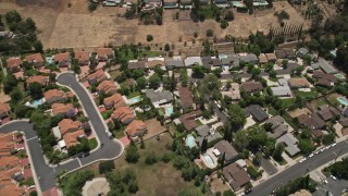 AX42_118 - 5K stock footage aerial video reverse view of tract homes with swimming pools in Calabasas, California