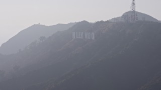 AX43_005 - 4K aerial stock footage flying by Hollywood Sign in fog, Los Angeles, California