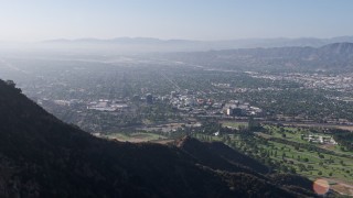 AX43_006 - 4K stock footage aerial video approaching, flying over Hollywood Sign, reveal Walt Disney Studios, Forest Lawn Cemetery in Burbank, Los Angeles, California