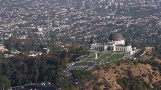 AX43_014 - 4K aerial stock footage flying by the Griffith Observatory overlooking the city of Los Angeles, California