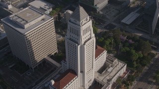 AX43_025 - 4K stock footage aerial video orbiting Los Angeles City Hall, Downtown Los Angeles, California