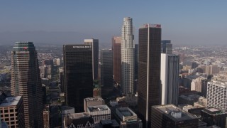 AX43_036E - 4K aerial stock footage flying over downtown skyscrapers to approach City National Plaza, US Bank Tower, and Aon Center, Downtown Los Angeles, California