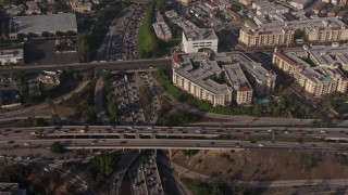 AX43_042 - 4K aerial stock footage of bird's eye of traffic on the I-110 / 101 interchange, panning to apartment buildings, Downtown Los Angeles, California