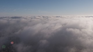 AX43_046 - 4K aerial stock footage flying over a marine layer covering Los Angeles, California