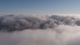 AX43_049 - 4K aerial stock footage flying above a thick marine layer over Los Angeles, California
