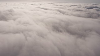 AX43_051 - 4K aerial stock footage flying by a dense, sunlit marine layer, Los Angeles, California