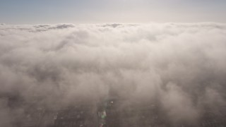 AX43_054E - 4K aerial stock footage flying by sunlit marine layer clouds, Los Angeles, California