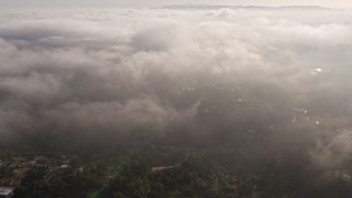 AX43_061 - 4K aerial stock footage flying by hazy marine layer rolling over Beverly Hills, California