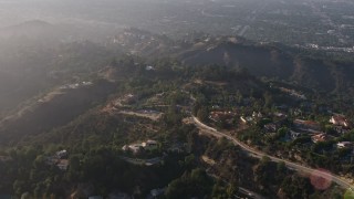 AX43_062 - 4K aerial stock footage passing by hilltop mansions in Beverly Hills, California