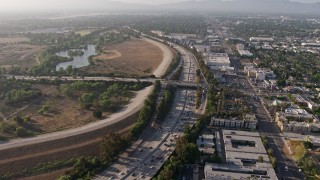 AX43_065 - 4K stock footage aerial video following heavy I-405 traffic by Woodley Park, Van Nuys, California, approach the Burbank Boulevard overpass