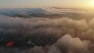 AX44_008 - 4K aerial stock footage of the marine layer over hills, Studio City, California, sunset