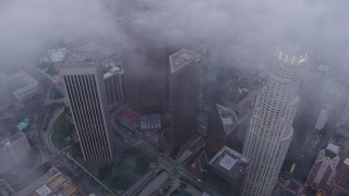 AX44_039 - 4K aerial stock footage circling above Downtown Los Angeles skyscrapers, California, twilight
