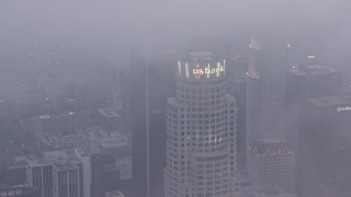 AX44_041 - 4K aerial stock footage of US Bank Tower covered in marine layer, twilight, Downtown Los Angeles