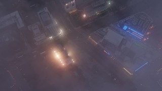 AX44_045 - 4K aerial stock footage of Staples Center and Nokia Theater through marine layer, Downtown Los Angeles, dusk