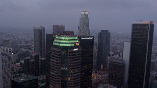 AX44_049 - 4K aerial stock footage flying by skyscrapers, Downtown Los Angeles, twilight