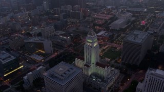 AX44_052 - 4K aerial stock footage orbiting City Hall revealing skyline, Downtown Los Angeles, twilight