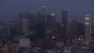 AX44_057 - 4K aerial stock footage approaching city through marine layer, Downtown Los Angeles, twilight
