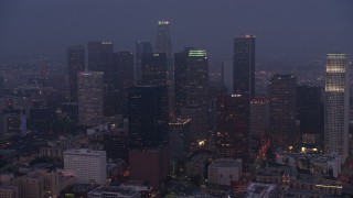 AX44_058 - 4K aerial stock footage approaching skyscrapers, Downtown Los Angeles, twilight