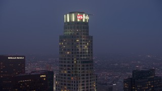 AX44_059 - 4K aerial stock footage orbiting top of US Bank Tower, Downtown Los Angeles, twilight