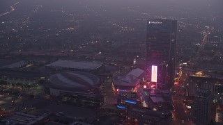 AX44_060 - 4K stock footage aerial video approaching Staples Center panning to The Ritz-Carlton, Los Angeles, twilight