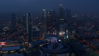AX44_063 - 4K stock footage aerial video approaching skyscrapers and high-rises, Downtown Los Angeles, twilight