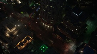 AX44_081 - 4K aerial stock footage of city streets and buildings, Downtown Los Angeles, night