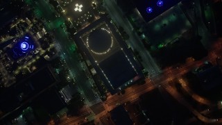 AX44_082 - 4K aerial stock footage of a bird's eye of city streets and buildings, Downtown Los Angeles, night