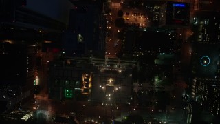 AX44_084E - 4K aerial stock footage of a bird's eye of city streets and buildings, Downtown Los Angeles, night