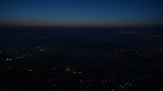 AX44_091 - 4K aerial stock footage of the marine layer over the city, Los Angeles, California, night