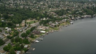 AX45_001 - 5K aerial stock footage flying by lakefront homes, Rainier Beach, Washington