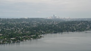 AX45_002 - 5K aerial stock footage of skyline seen from lakefront homes, Rainier Beach, Seattle, Washington