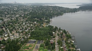 AX45_004 - 5K aerial stock footage of suburban homes near the lake, Pritchard Island Beach park, Rainier Beach, Washington