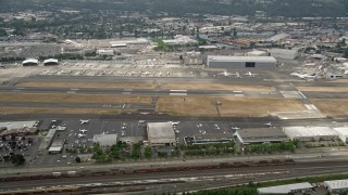 AX45_010E - 5K aerial stock footage of parked commercial jets at Boeing Field, Seattle, Washington