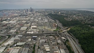 AX45_014 - 5K aerial stock footage tilting from Interstate 5 to reveal warehouse buildings and Downtown Seattle, Washington