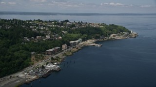 AX45_018E - 5K aerial stock footage flying by waterfront apartment buildings and hilltop homes, West Seattle, Washington